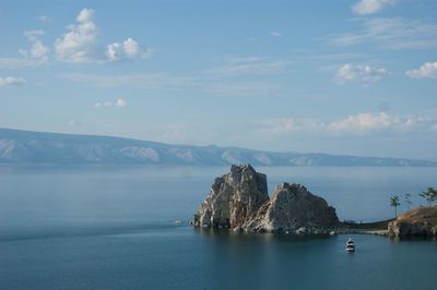 Scenic view of sea and mountains against sky