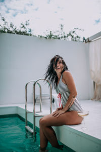 Woman sitting in swimming pool