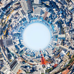 Directly below shot of buildings against sky in city