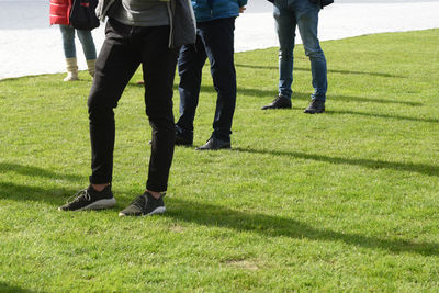 Low section of people standing on field