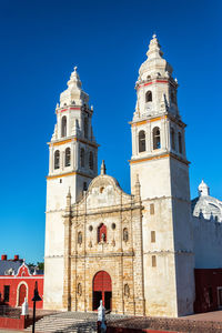 Low angle view of bell tower against blue sky