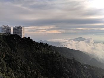 Scenic view of buildings and mountains against sky