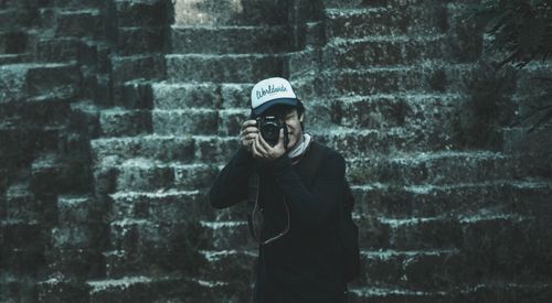 Man standing against wall