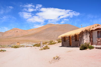 View of desert against cloudy sky