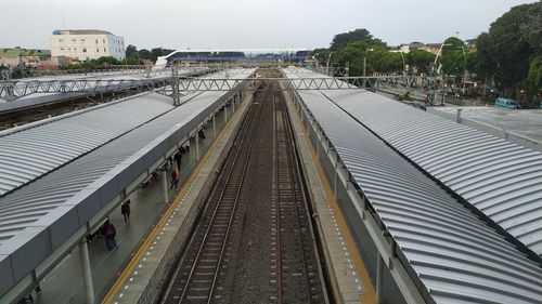 High angle view of railroad tracks in city against sky