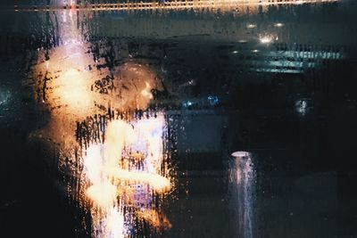 Close-up of illuminated water in rain