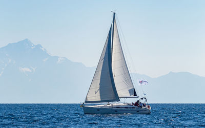 Sailboat sailing on sea against clear sky