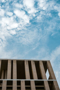 Low angle view of building against cloudy sky