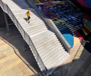 High angle view of man walking on staircase