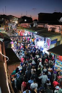 High angle view of people on street amidst buildings in city