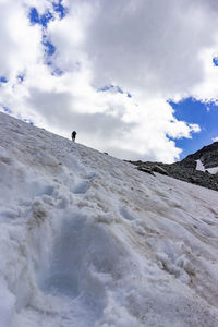 Man on snowcapped mountain against sky