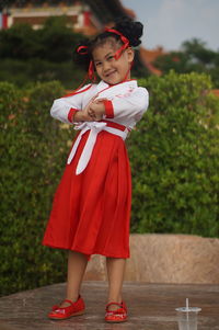 Portrait of smiling girl standing outdoors