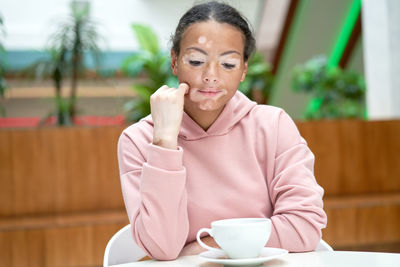 Portrait of woman with coffee cup