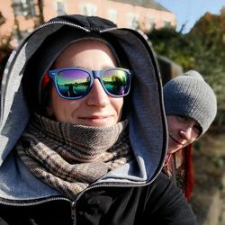 Portrait of young woman wearing sunglasses and warm clothing