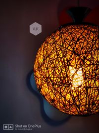 Low angle view of illuminated light fixture on ceiling