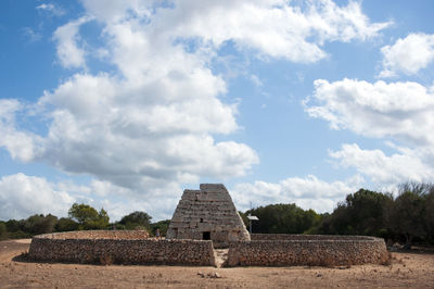 La naveta d'es tudons, funerary chamber in menorca - scenic view of field against sky