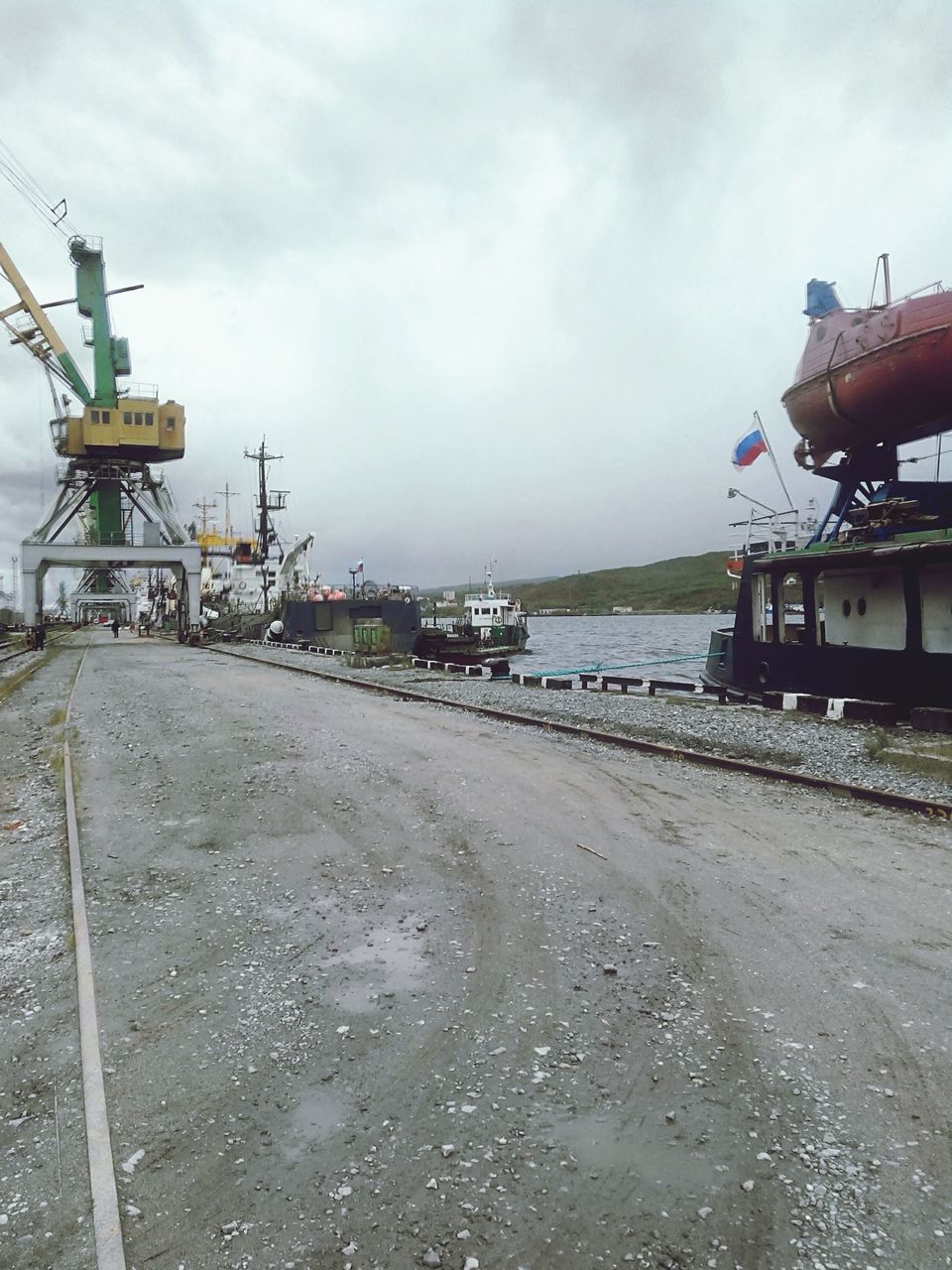 water, sky, sea, built structure, nautical vessel, transportation, pier, cloud - sky, architecture, mode of transport, building exterior, incidental people, beach, moored, cloudy, harbor, nature, outdoors, boat, day