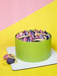 High angle view of food in container against pink background