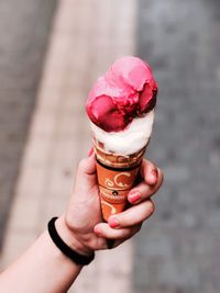 Cropped image of hand holding ice cream cone