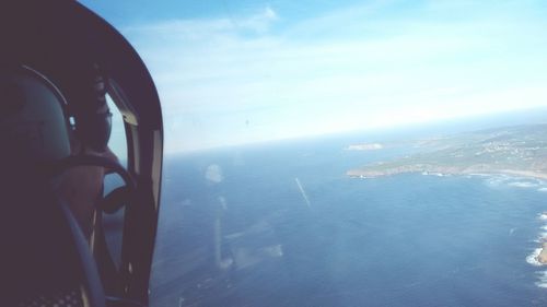 Aerial view of landscape against blue sky