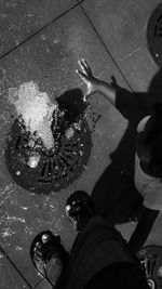 Low section of woman standing on tiled floor