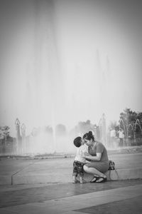 Mother with son against fountain