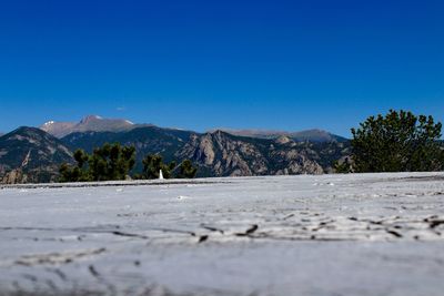 Surface level of land against clear blue sky