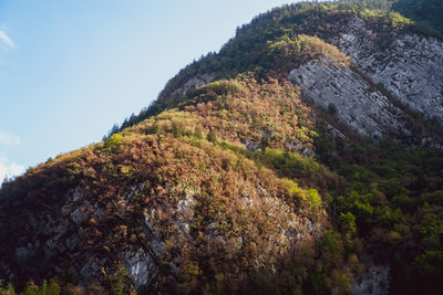 Low angle view of rocks on mountain against sky