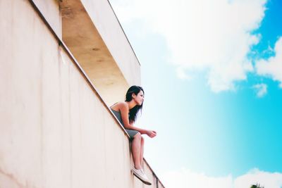 Low angle view of woman against sky