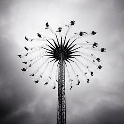 Low angle view of ferris wheel against sky