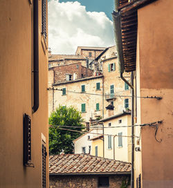 Buildings in town against sky