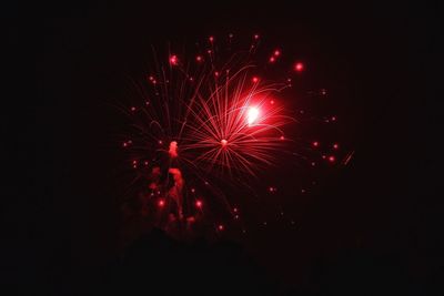 Low angle view of firework display at night