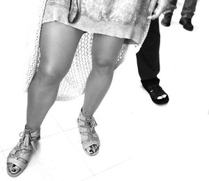 Low section of woman standing on tiled floor