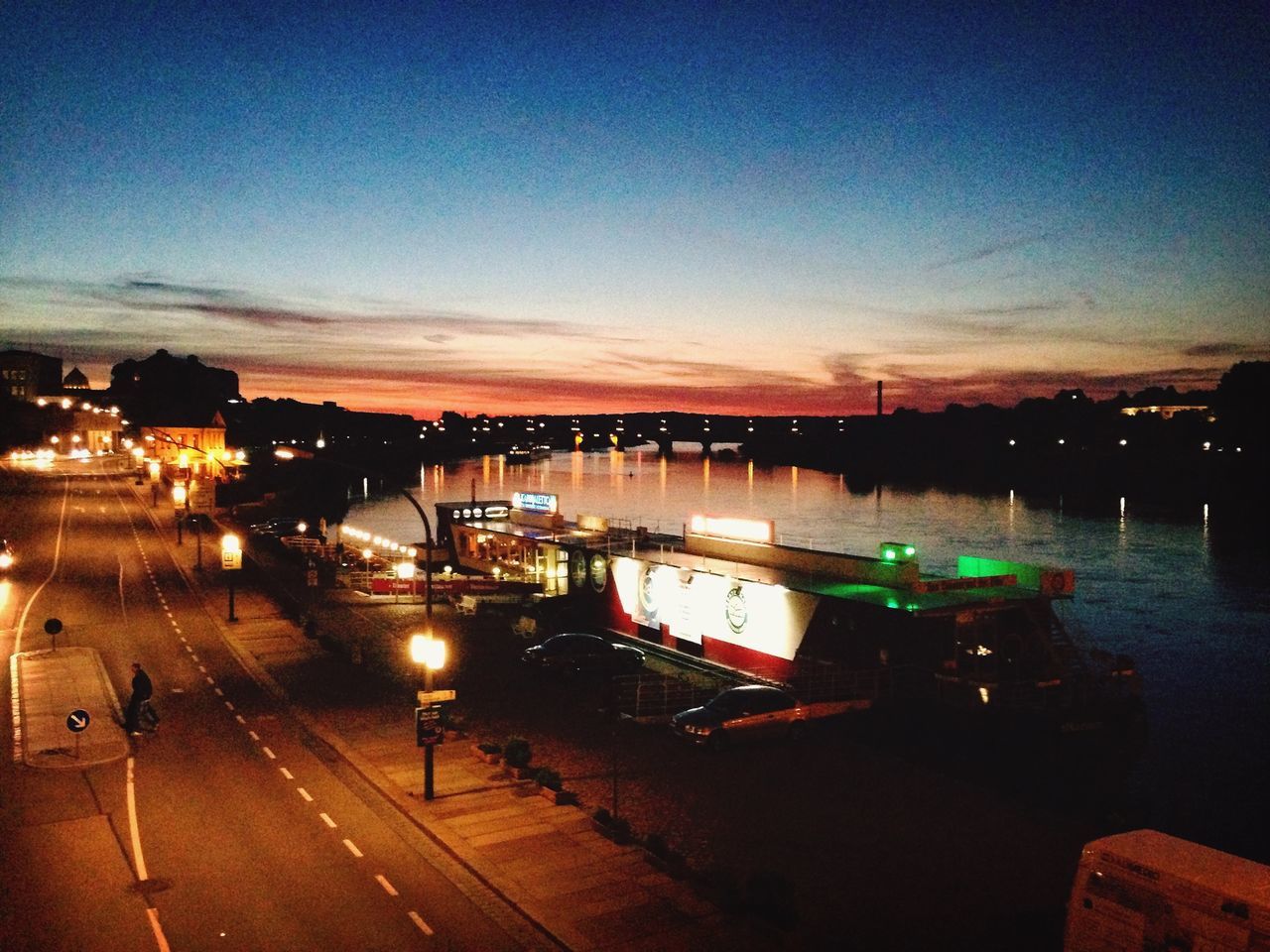 illuminated, transportation, water, built structure, architecture, night, building exterior, mode of transport, dusk, copy space, river, clear sky, high angle view, sky, sunset, city, nautical vessel, reflection, blue, boat