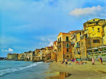 Scenic view of sea with buildings in background