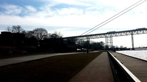 Railroad tracks against cloudy sky