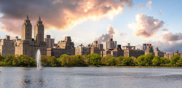 Buildings in city against sky during sunset