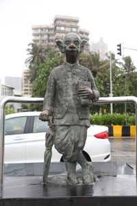 Statue against sky in city