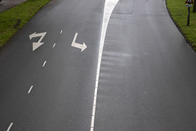 High angle view of arrow symbol on road in city