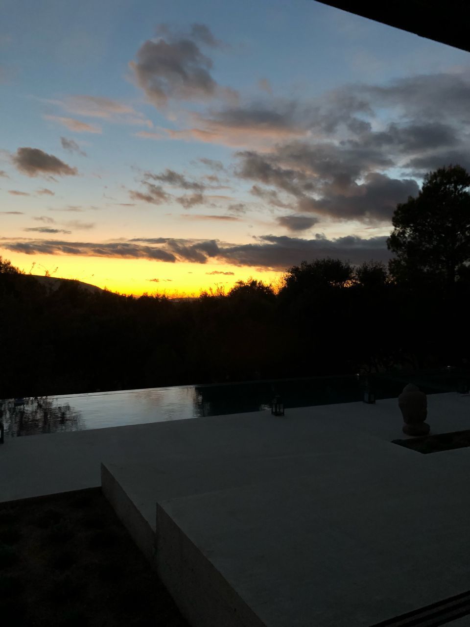 SCENIC VIEW OF SWIMMING POOL AGAINST SKY DURING SUNSET