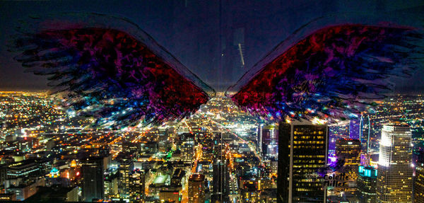 Illuminated city against sky at night