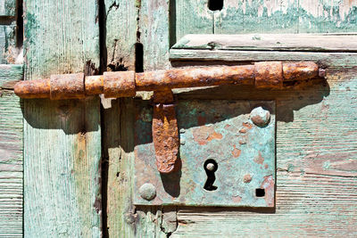 Close-up of padlock on wooden door