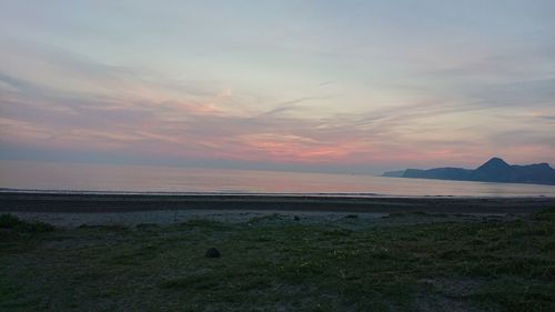 Scenic view of beach against sky during sunset