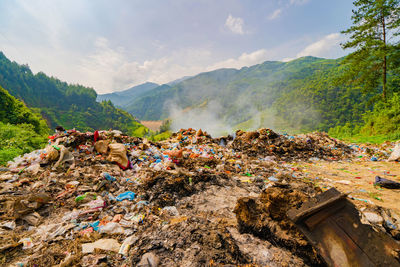 Garbage on mountain range against sky