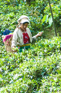 Woman standing by plants