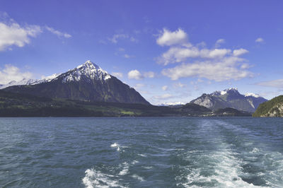 Scenic view of sea and mountains against sky