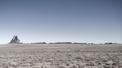 Scenic view of arid landscape against clear sky