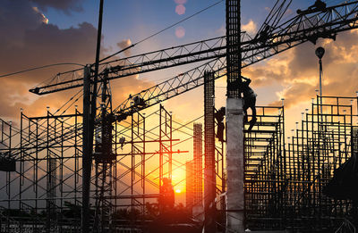 Silhouette electricity pylon against sky during sunset