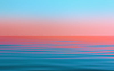 Reflection of the sunset in the flowing water. blue and pink seascape background with  copy space.