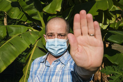 Close-up portrait of man making plants